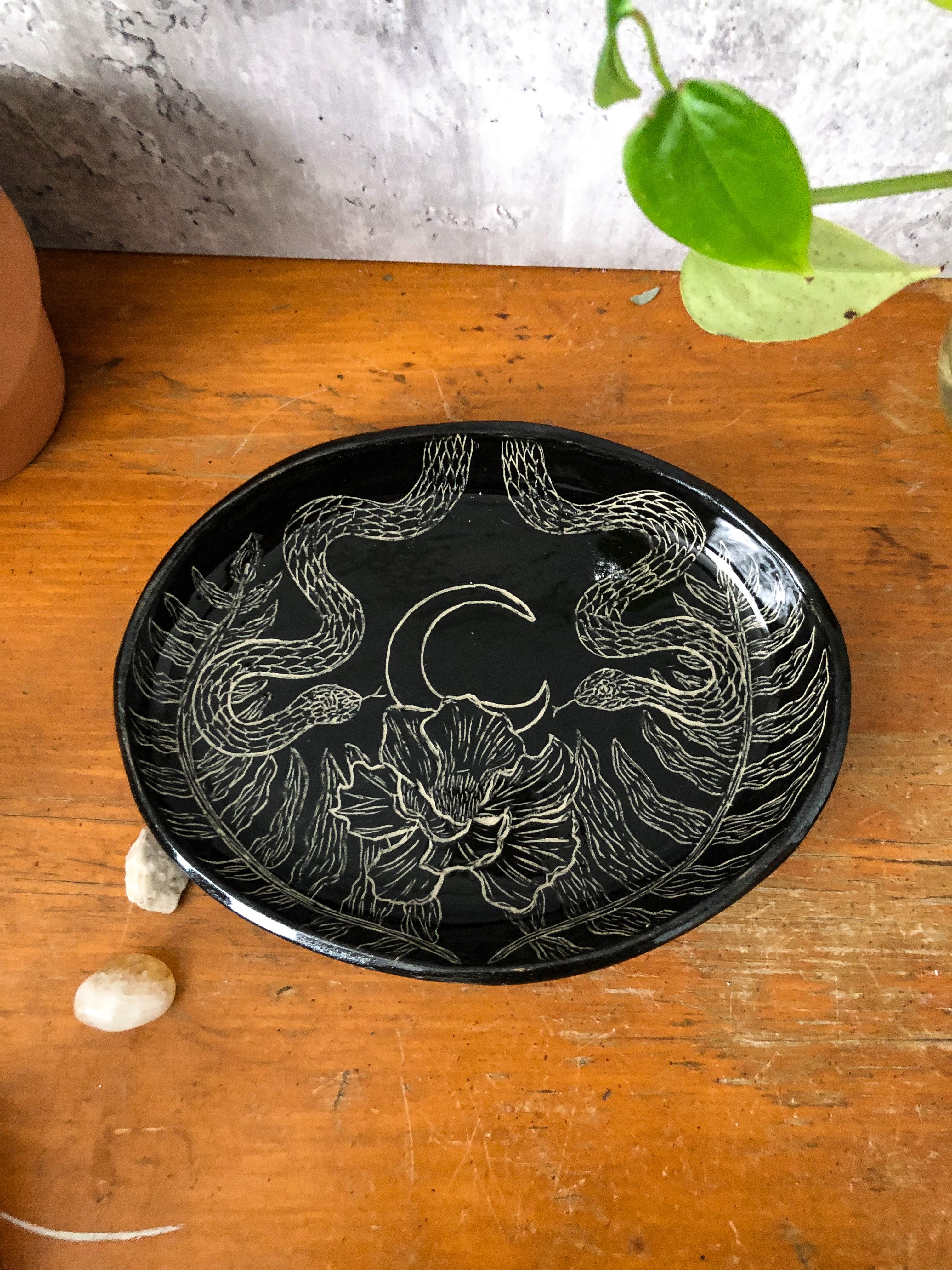 Made and carved by hand, the platter is alive with night critters